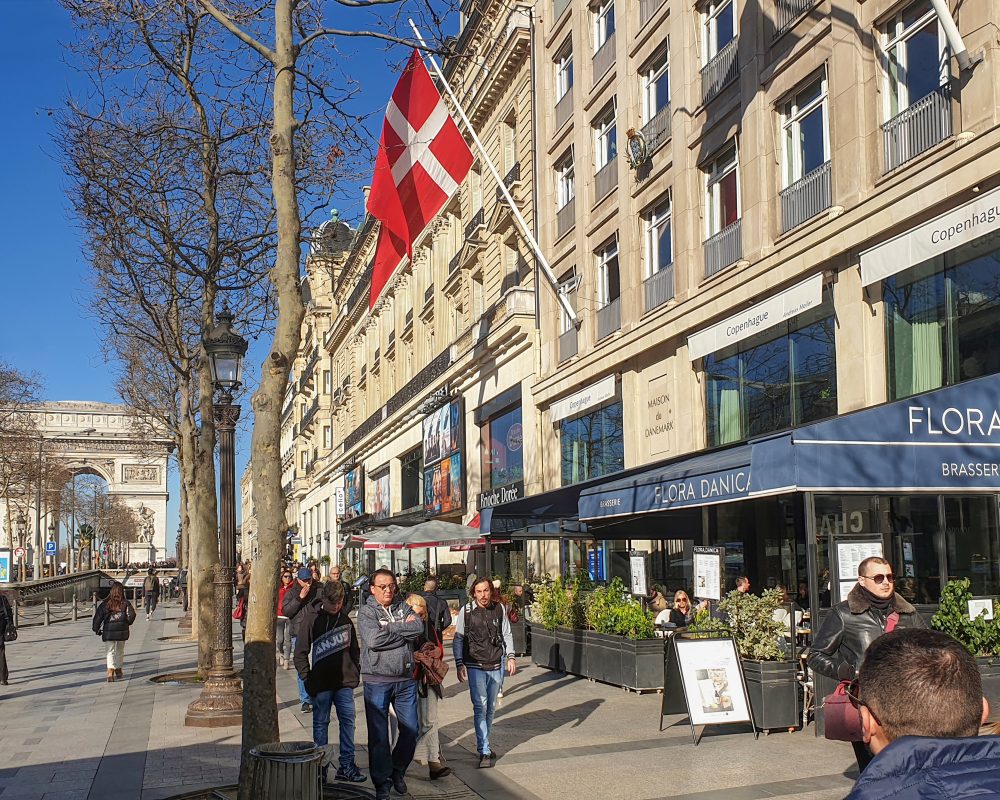 Maison du Danemark fra gaden med det danske flag, der flagrer i vinden.